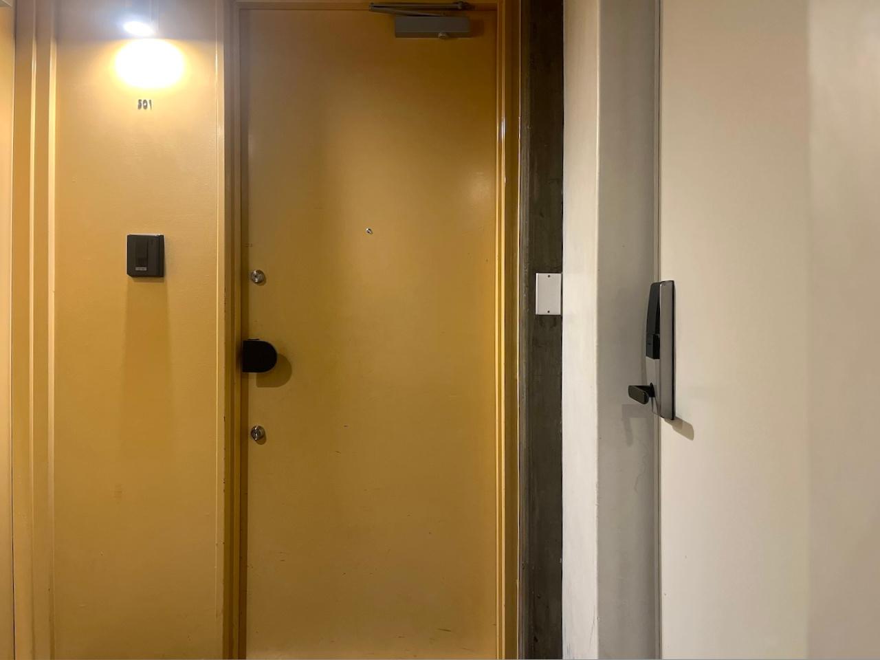 福岡市博多区古門戸町の賃貸物件/玄関入り口は薄黄色。右側の白い扉を開けるとランドリースペース。