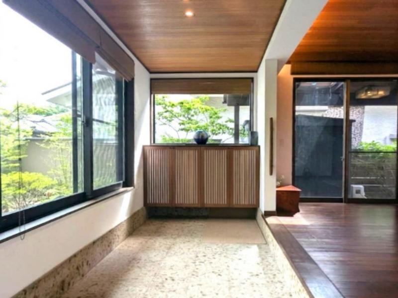 鎌倉市浄明寺四丁目の売買物件/1階 玄関土間｜立ち上がりの巾木にまで石を張った贅沢なつくり。正面の窓は、壁の幅いっぱいにサッシ枠を納める施工の難しい意匠です