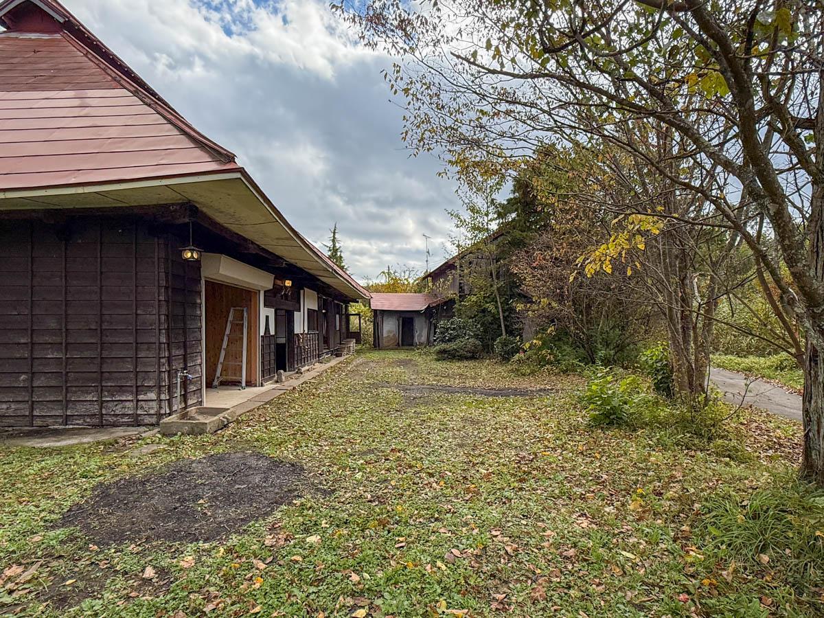 長野県上水内郡信濃町富濃の売買物件/緑が茂る広い平地。奥には大正2年（1913年）築の古い蔵もあります