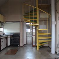 山形市あこや町の売買物件/黄色い螺旋階段と吹き抜けが特徴のダイニングスペース。